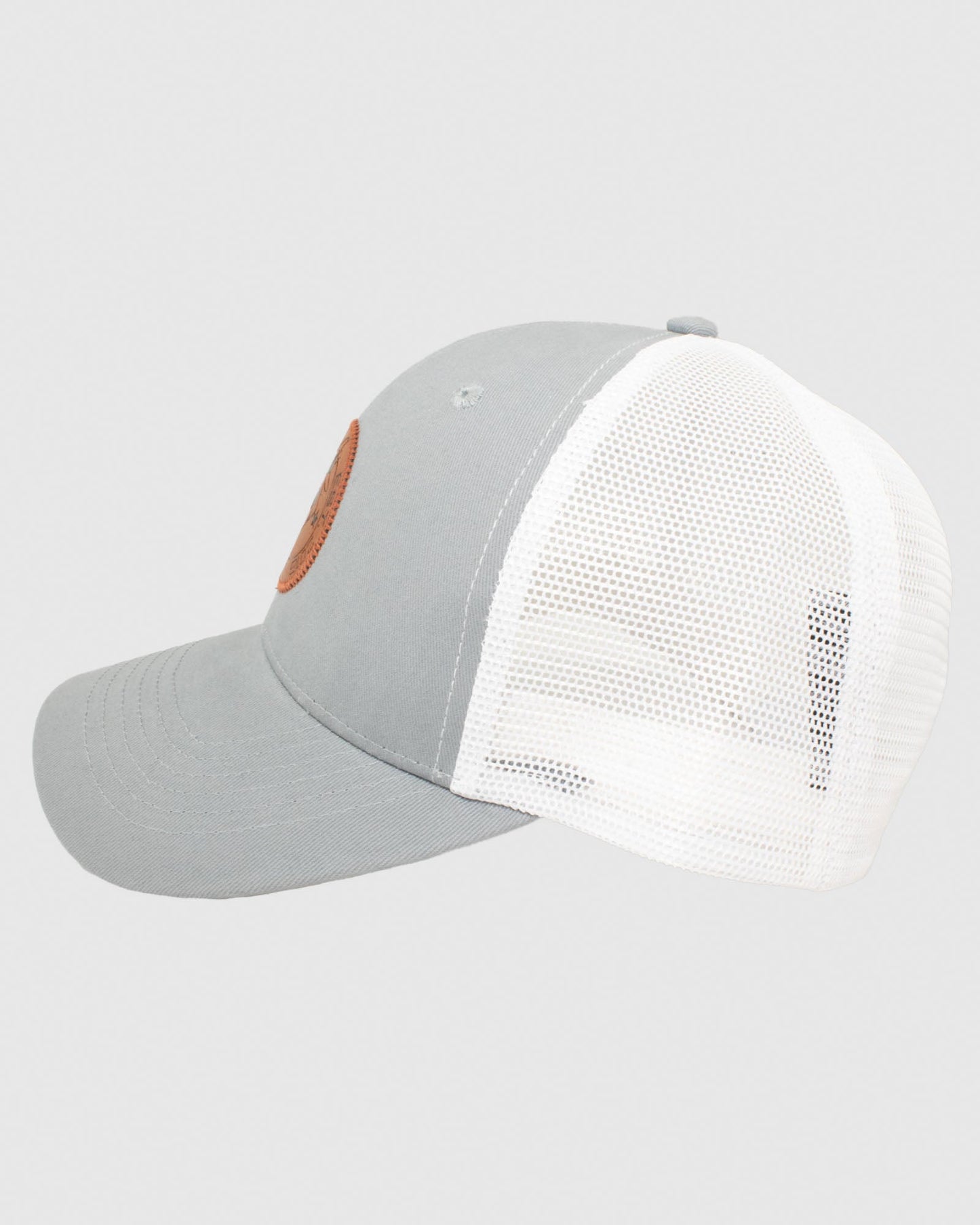 Side view of gray hat with white mesh and brown leather patch#color_charcoal