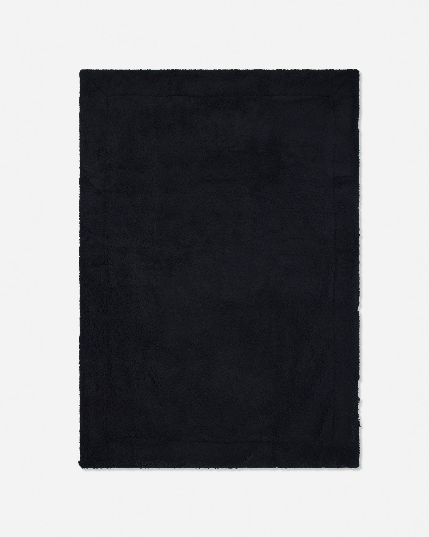 A solid black rectangular blanket with frayed edges, shown flat against a light gray background.