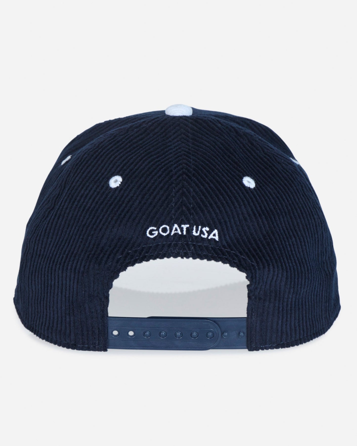 The back of a dark navy blue corduroy baseball cap featuring 'GOAT USA' embroidered in white on the front, with a white snapback closure at the bottom.