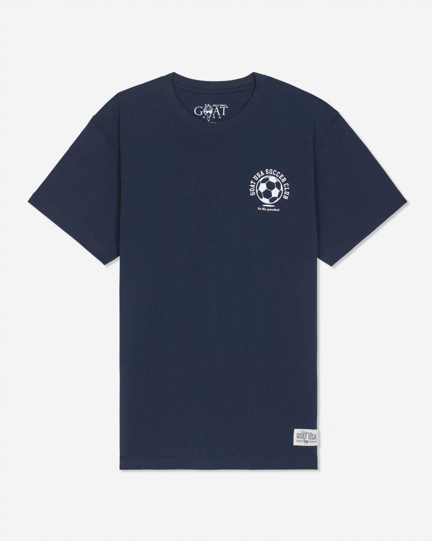 A navy blue short-sleeve t-shirt with a white circular soccer-themed graphic on the left chest and a white 'GOAT' brand print inside the collar, displayed on a light gray background.
