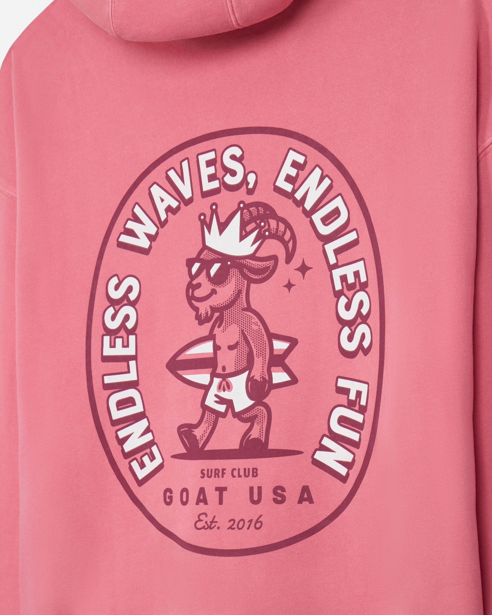 Salmon-colored hoodie with a graphic design of a goat and text on a pink background