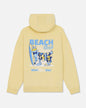 Yellow hoodie with a graphic of a goat, surfboard, and text on the back against a white background