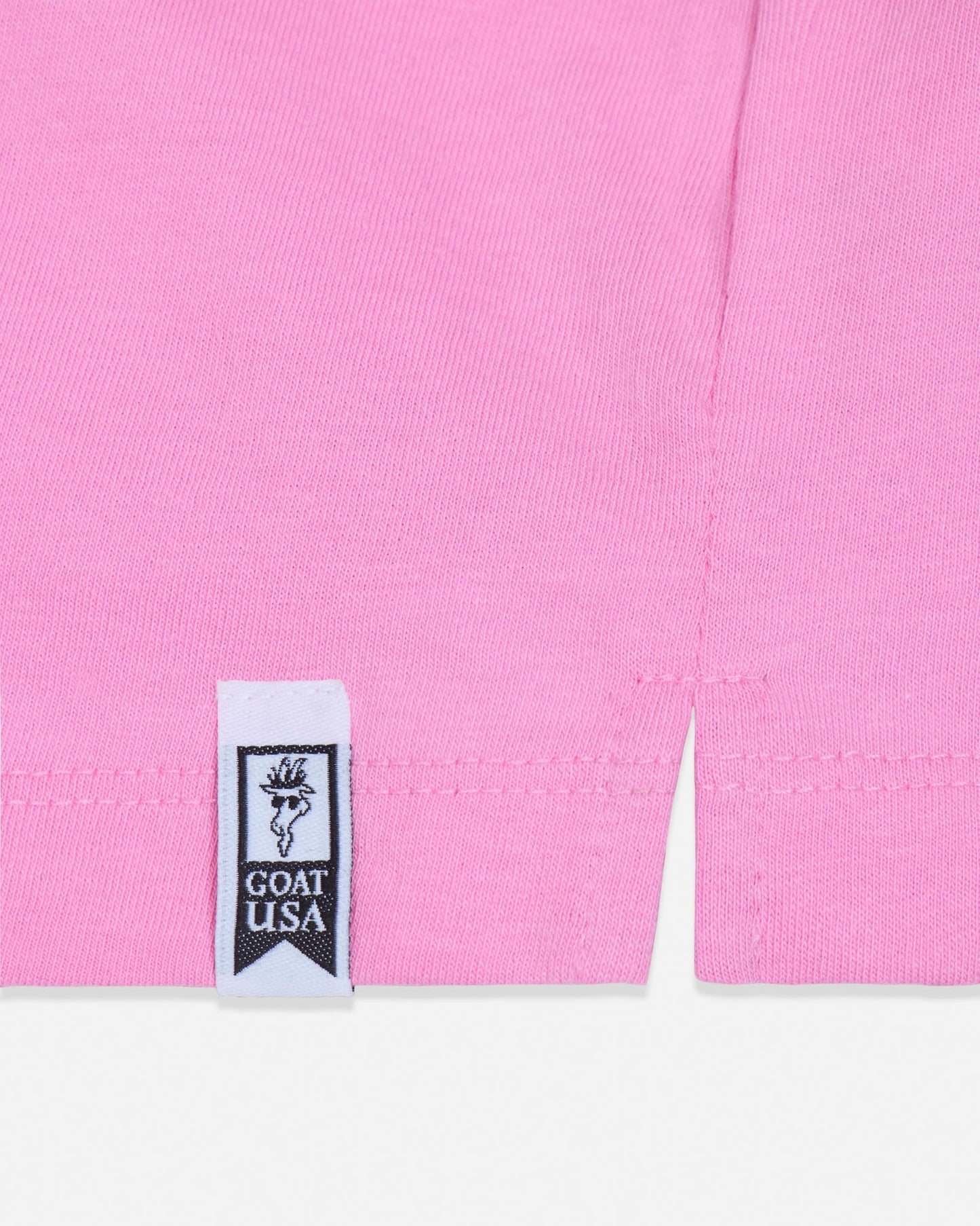 Close-up of a pink garment with a visible label on a white background