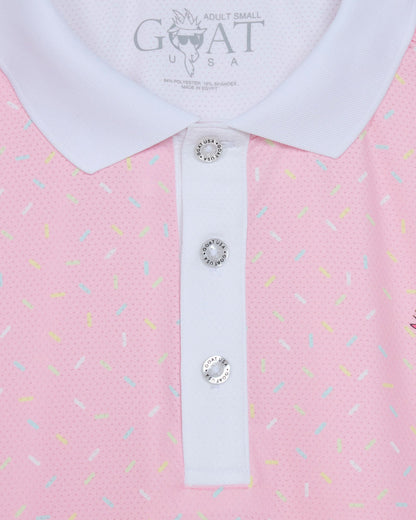 Pink polo shirt with white collar and decorative buttons, featuring the brand 'GOAT USA'.