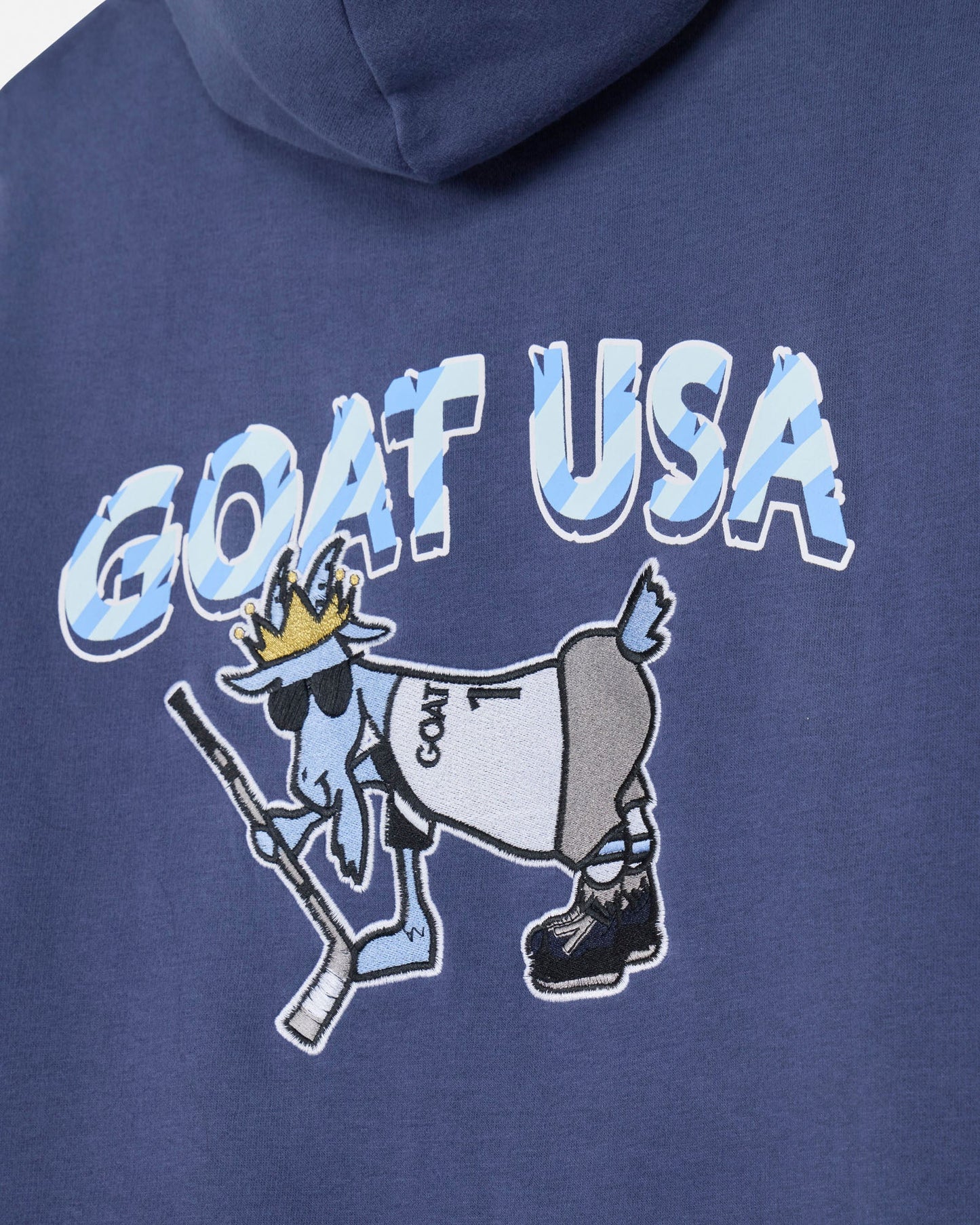 Blue hoodie with 'GOAT USA' graphic design featuring a goat with a crown and hockey stick.