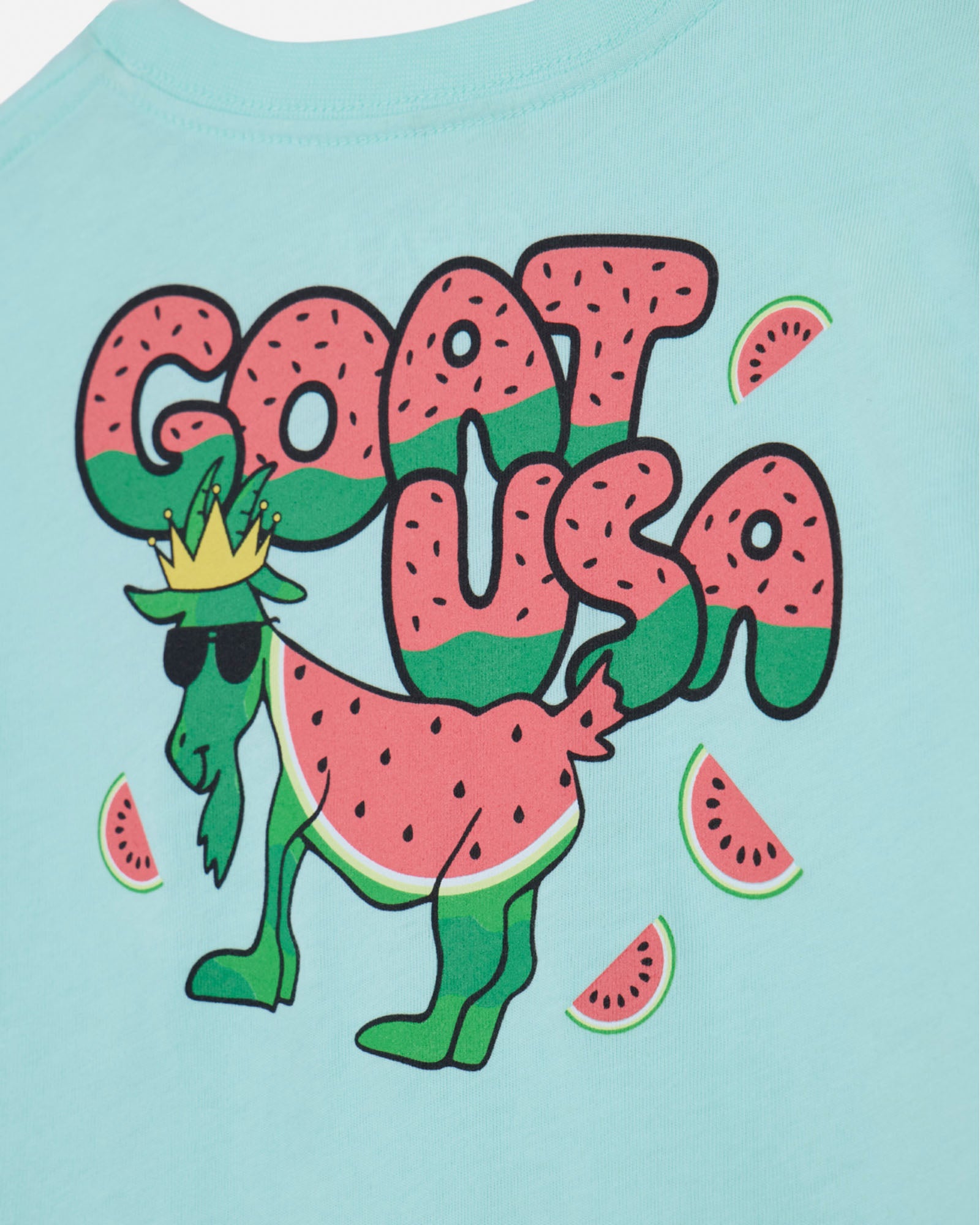 T-shirt with a graphic of a goat holding watermelon slices and the text 'GOAT USA' on a light blue background.