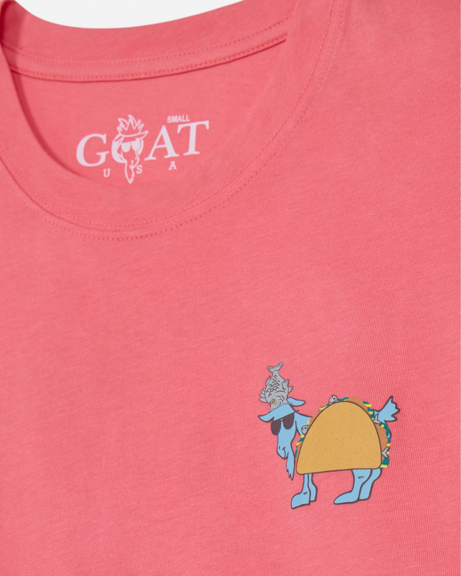 Pink t-shirt with a cartoon character wearing a taco and the brand 'GOAT' logo.