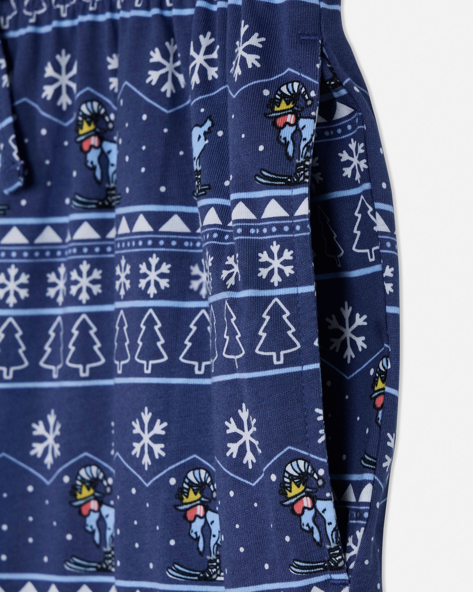 Navy blue fabric with white snowflake, tree, and skier pattern