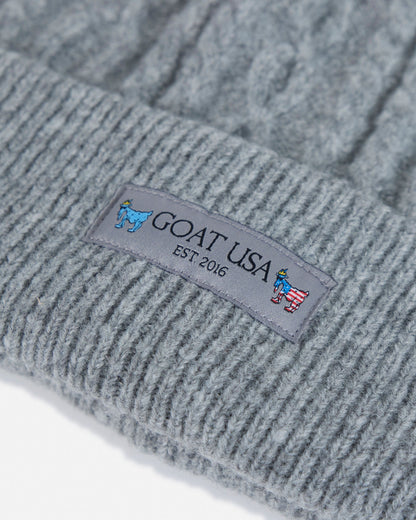 Gray knit beanie with 'GOAT USA' logo on a white background