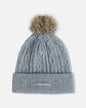 Gray knit beanie with a fur pom-pom on a light gray background