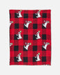Red and black checkered blanket with cartoon goat design on a white background