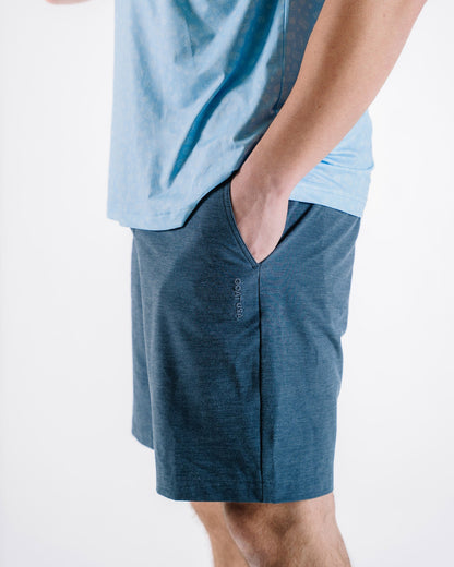 Side view on model of navy hybrid short#color_navy