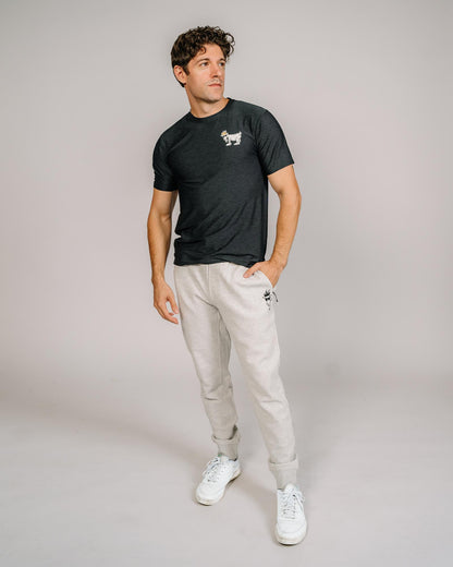 Male model wearing black performance joggers#color_pale-gray