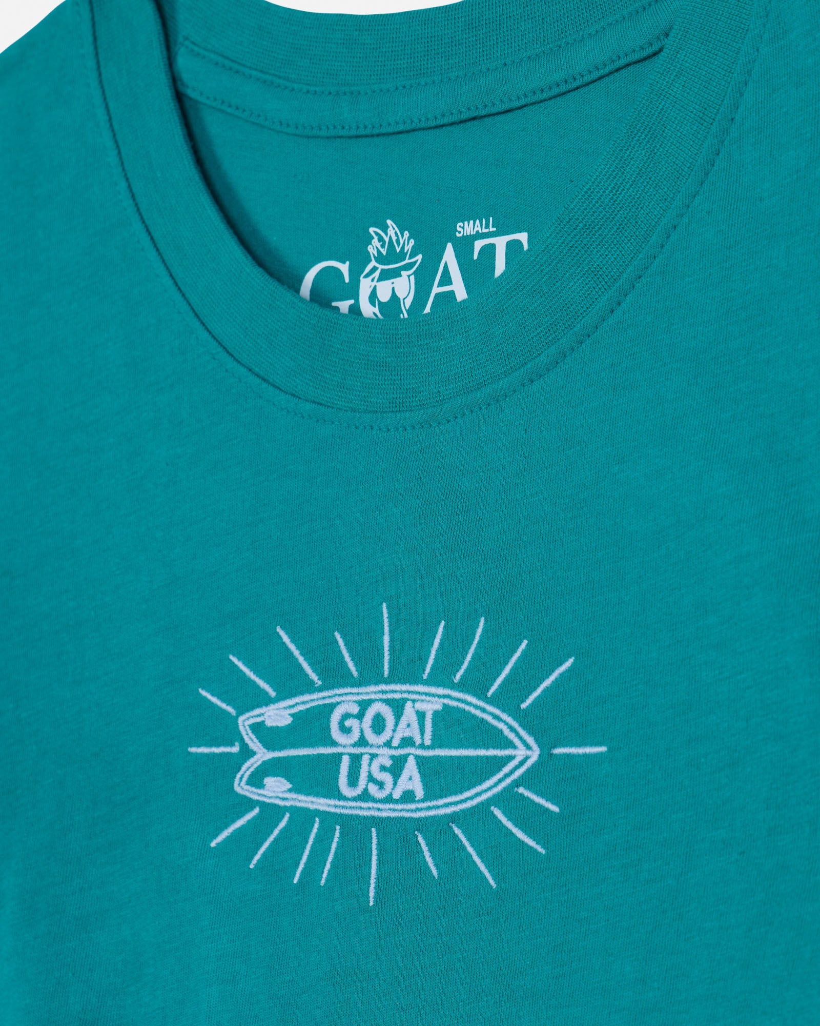 Teal tank top with white graphic and 'GOAT USA' text