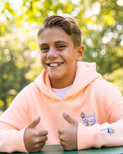 Kid wearing peach cream WG Hooded Sweatshirt#color_peach-cream