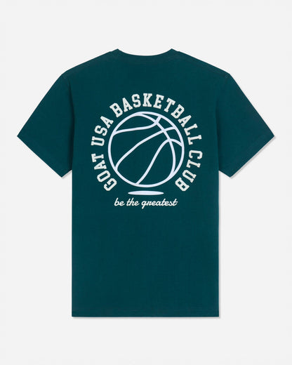 A dark teal green short-sleeve t-shirt with a white graphic print on the back featuring a basketball and the text 'GOAT USA BASKETBALL CLUB' and 'be the greatest'.