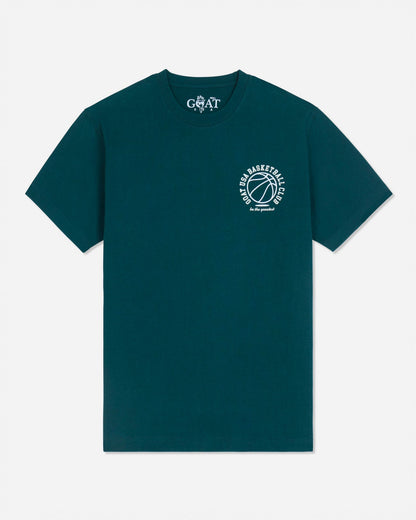 A dark teal green short-sleeve t-shirt with a white circular graphic on the left chest featuring a basketball and the text 'GOAT BASKETBALL'. The inner neck label shows the brand 'GOAT'.