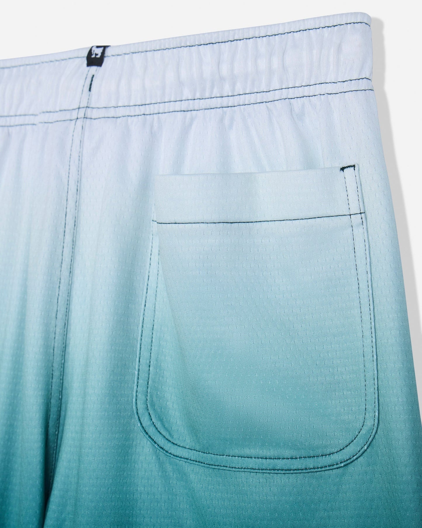 Close-up of back pocket on sage fade mesh shorts#color_sage