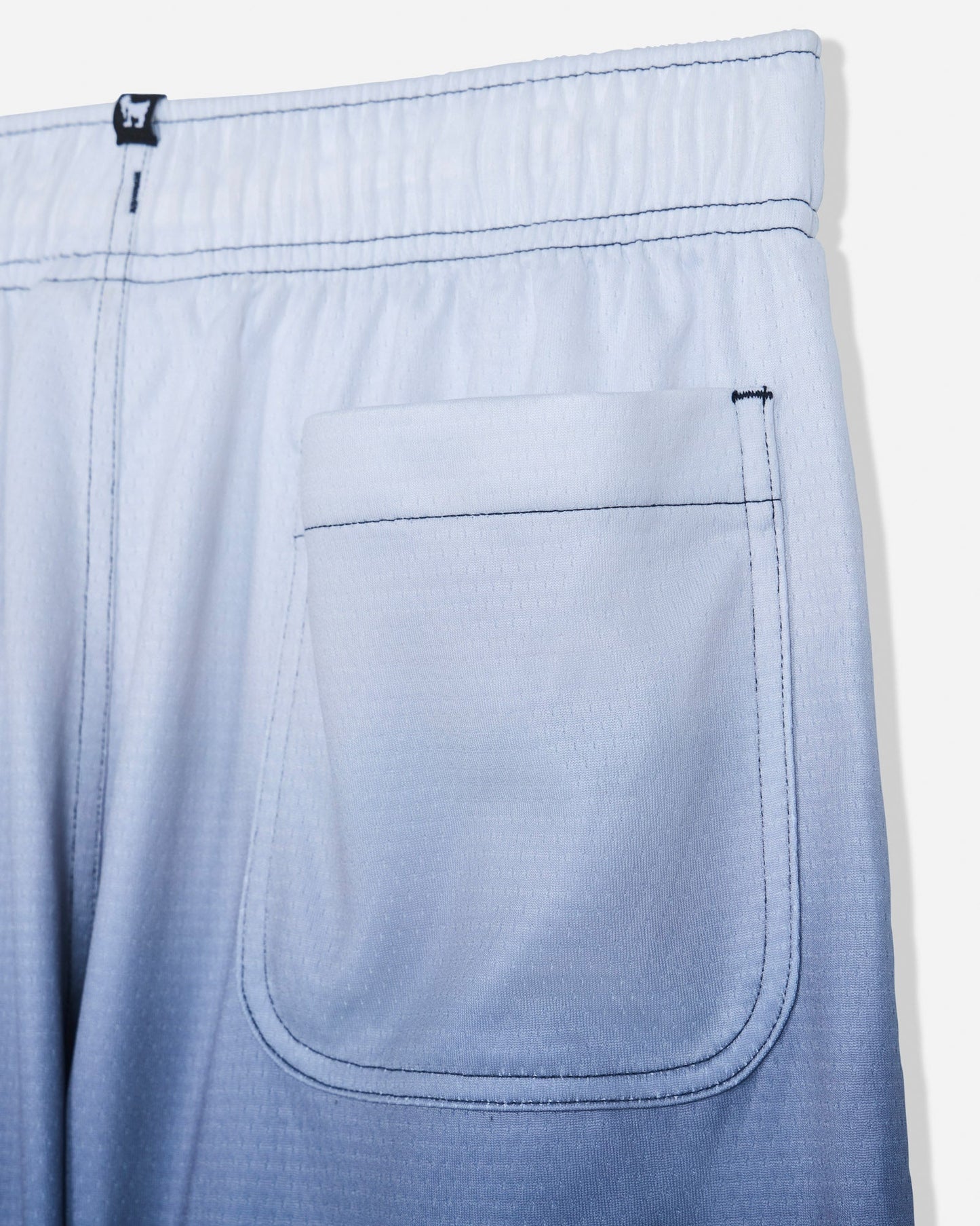 Close-up of back pocket on navy fade mesh shorts#color_navy-blazer