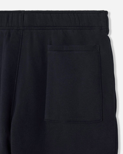 Close-up of black pants with a button on a white background#color_black