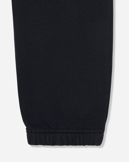 Close-up of a black fabric garment leg with an elasticized cuff, shown against a light gray background.#color_black
