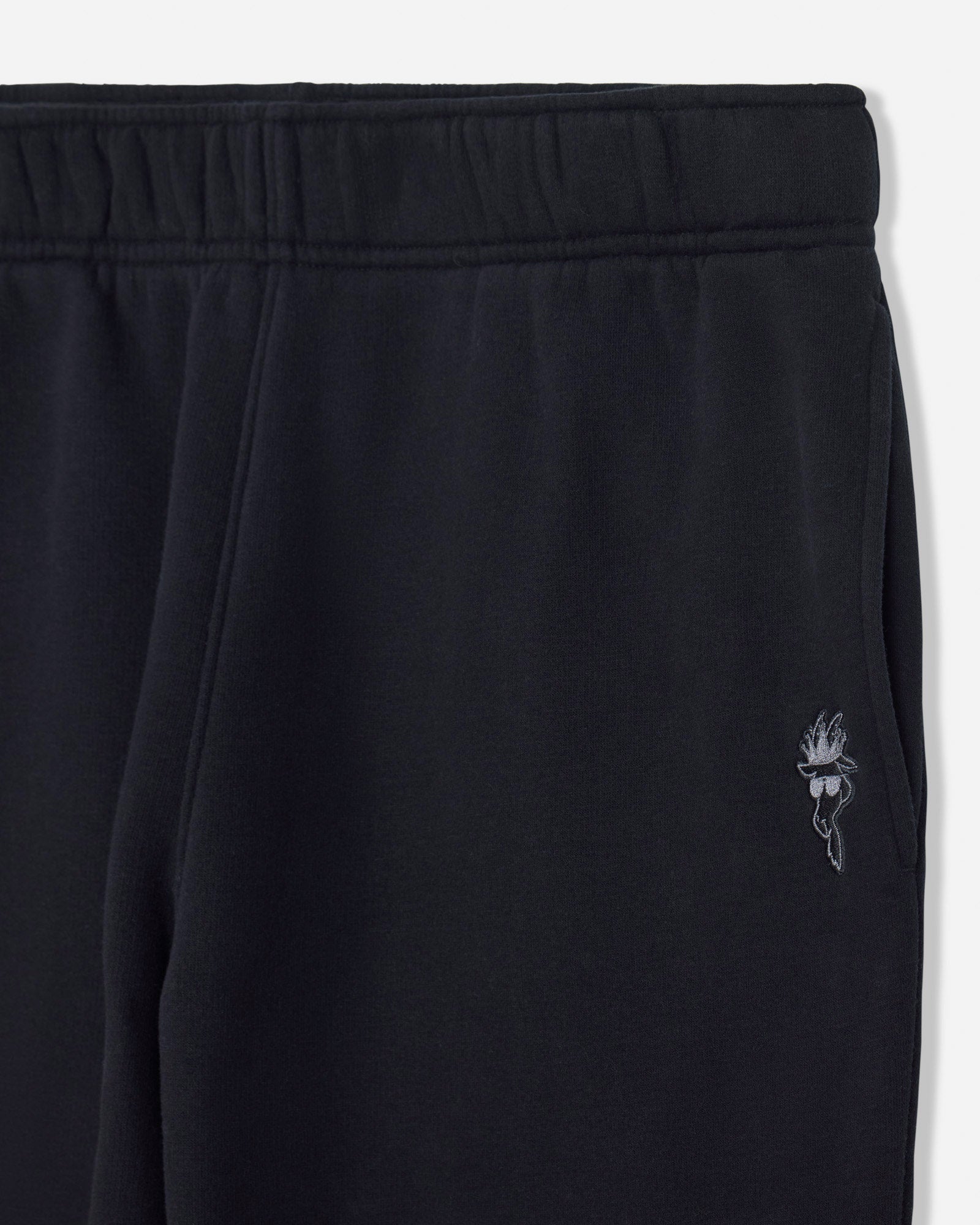 Black sweatpants with a brand logo on a white background#color_black