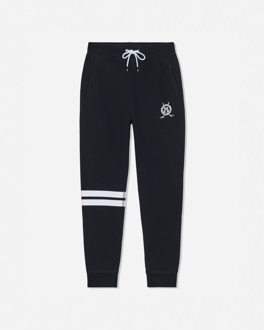 Black sweatpants with a white drawstring, a small white crest logo on the left thigh, and two horizontal white stripes near the lower left leg, shown against a light gray background.