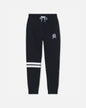 Black sweatpants with a white drawstring, a small white crest logo on the left thigh, and two horizontal white stripes near the lower left leg, shown against a light gray background.