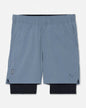 Pair of gray shorts with a black liner on a white background#color_storm-gray