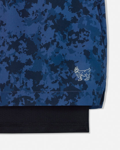 Blue camouflage shorts with a brand logo on a white background#color_navy-camo