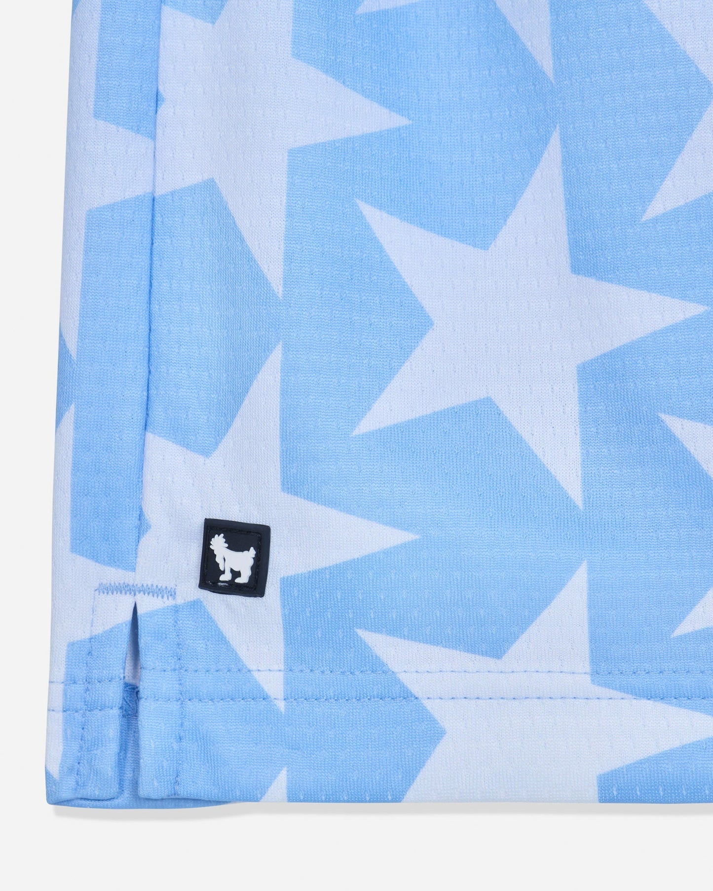 Close-up of rubber patch of carolina blue mesh shorts with a star pattern#color_carolina-blue