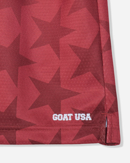 Front of red mesh shorts with a star pattern and stitched 'GOAT USA' text#color_tomato