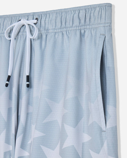 Close-up of pocket on gray mesh shorts with a star pattern#color_gray