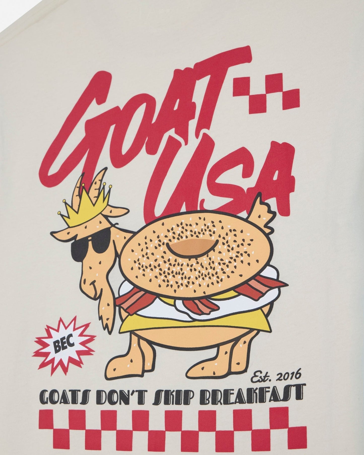 T-shirt with a cartoon goat bagel and text 'GOAT USA' on a beige background