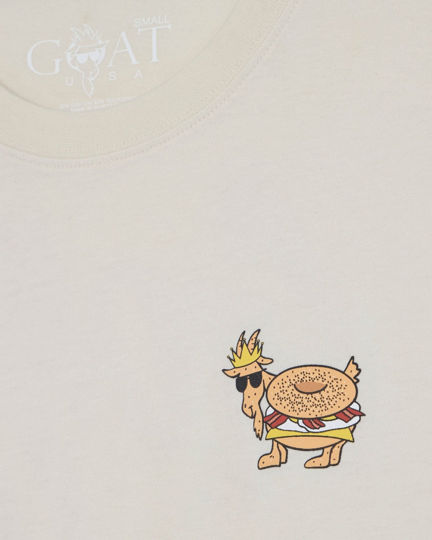 Cartoon character with a crown and hat on a beige t-shirt