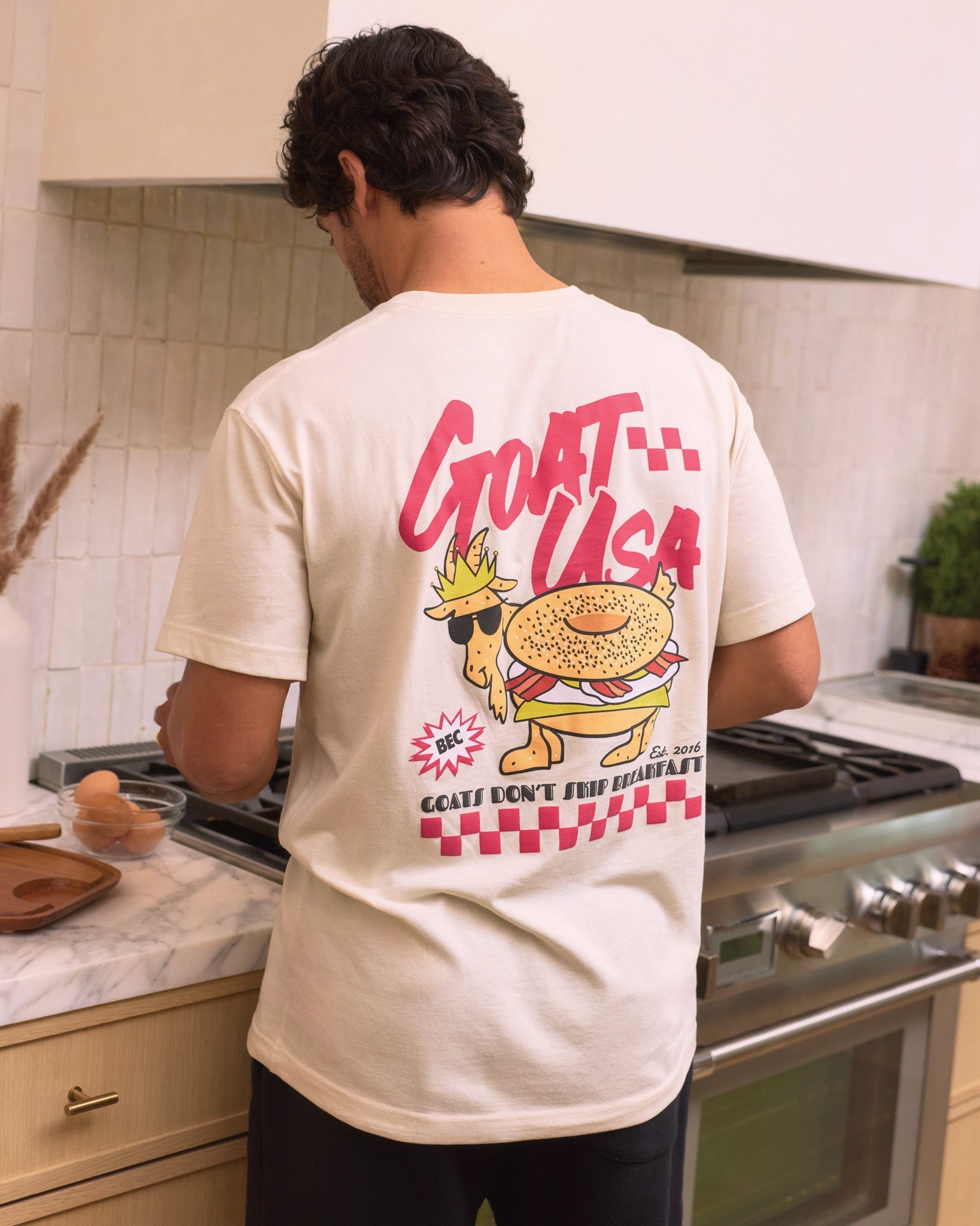 Person wearing a t-shirt with a graphic design in a kitchen