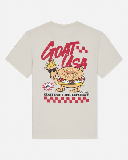 Beige t-shirt with a cartoon goat wearing sunglasses and a crown, labeled 'GOAT USA', on a white background.