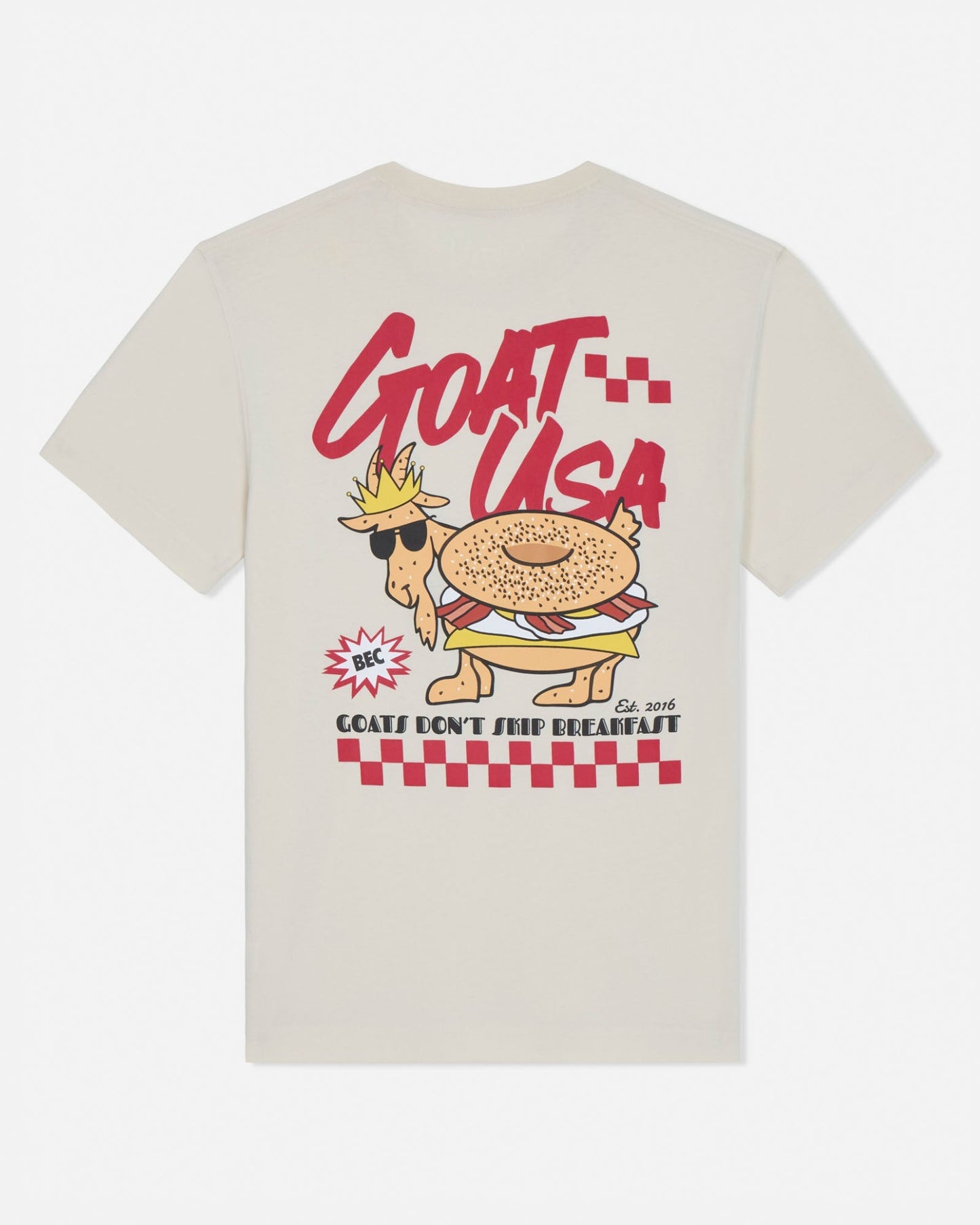Beige t-shirt with a cartoon goat wearing sunglasses and a crown, labeled 'GOAT USA', on a white background.