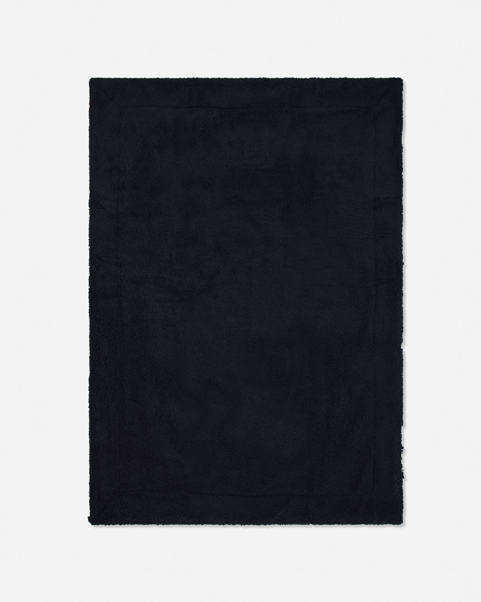 A solid black rectangular blanket with frayed edges, shown flat against a light gray background.