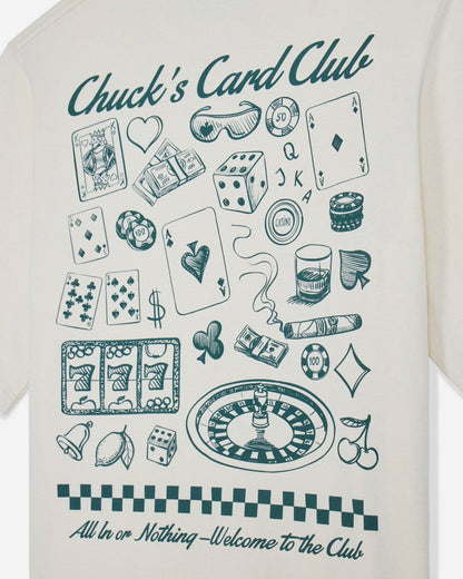 Close-up of bone t-shirt with casino games design and text that reads "Chuck's Card Club All In or Nothing - Welcome to the Club"