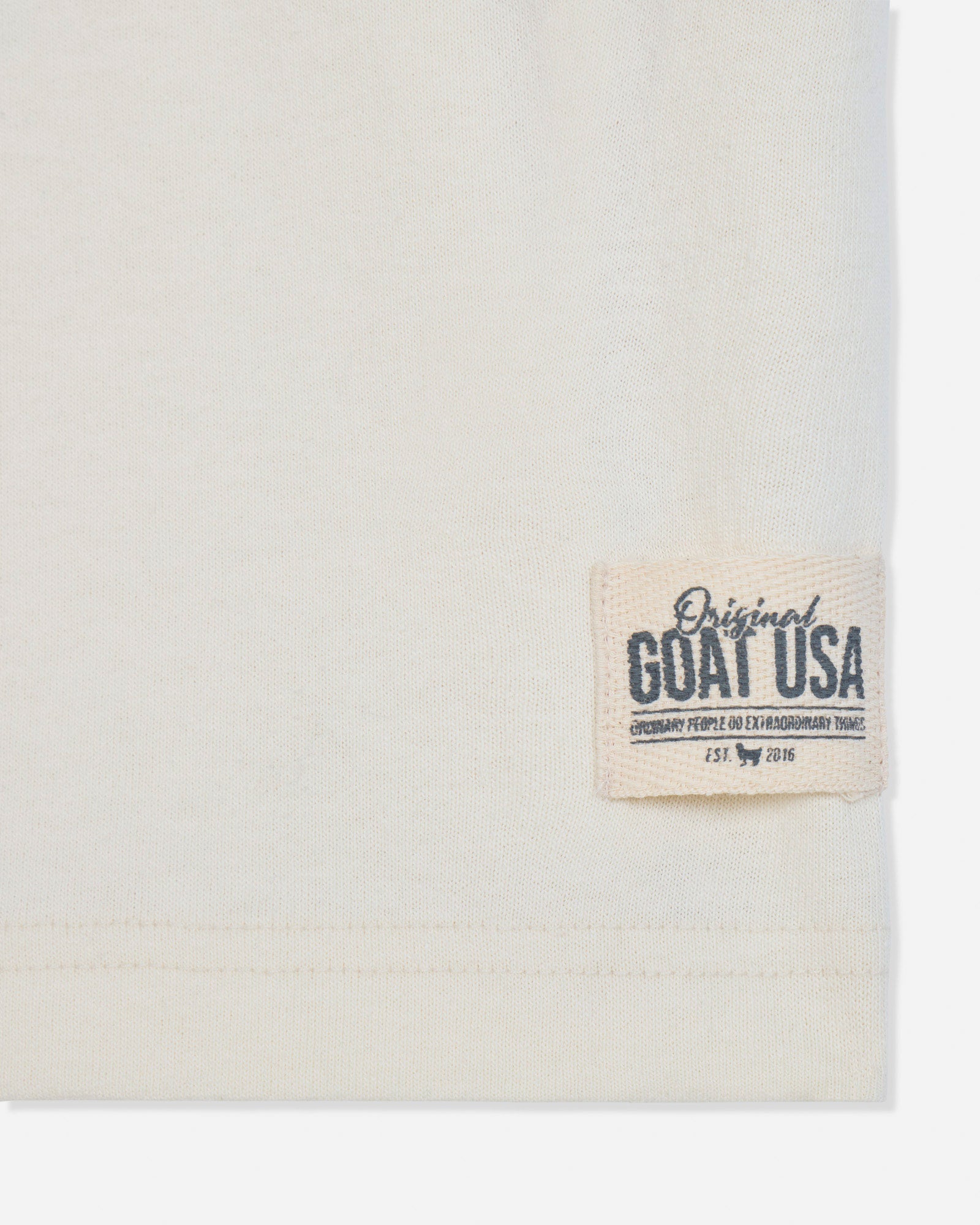 Close-up of stitched patch on bone t-shirt