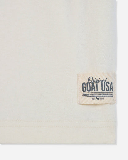 Close-up of stitched patch on bone t-shirt