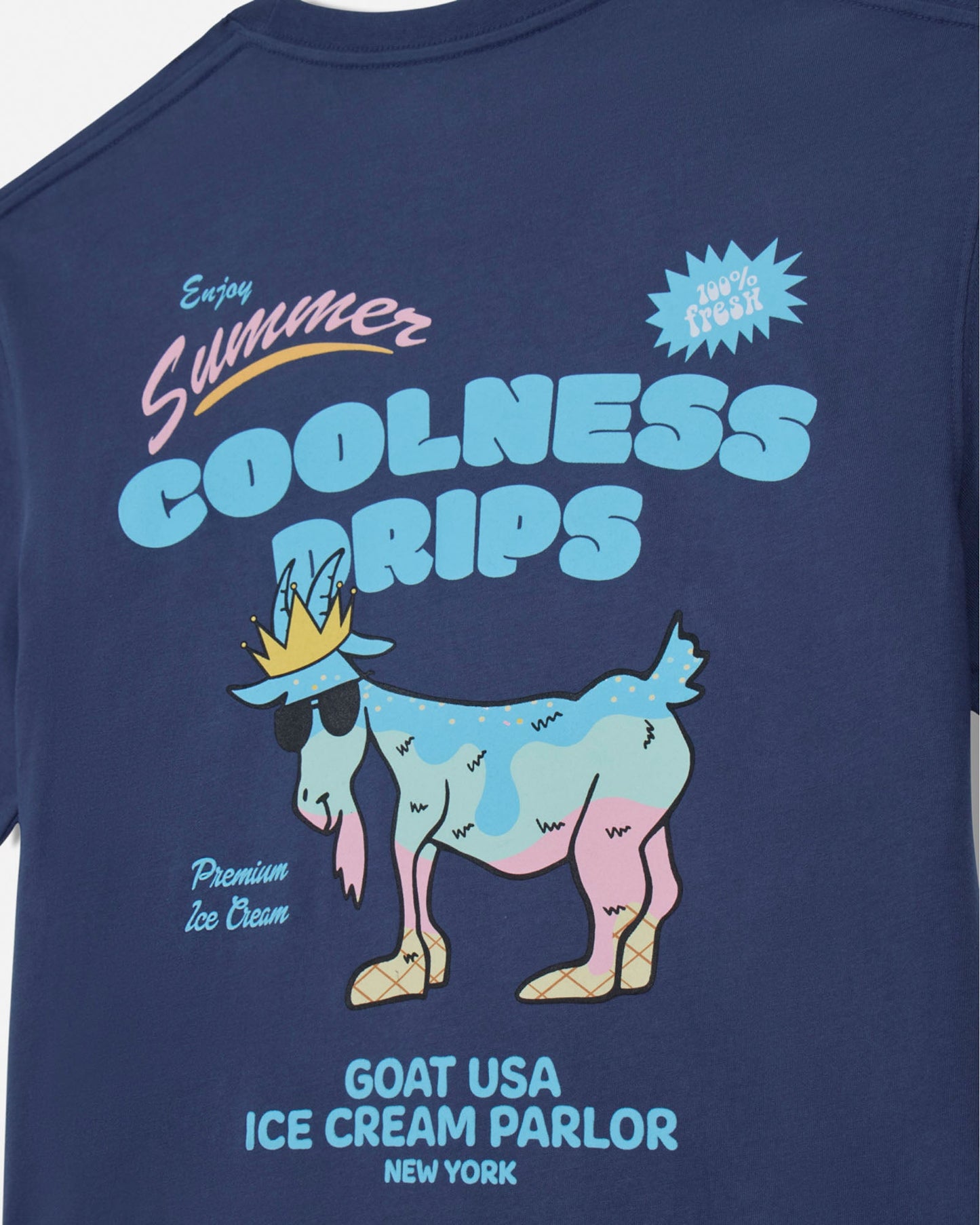 Navy blue t-shirt with a cartoon goat wearing a crown and ice cream, text 'Summer Coolness Drips' and 'Goat USA Ice Cream Parlor New York'.
