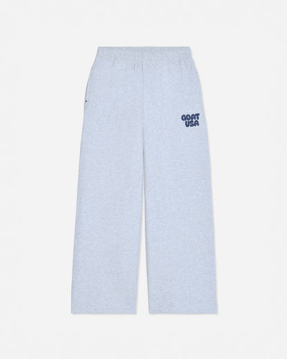 Light heather gray wide-leg sweatpants with a small navy blue 'GOAT USA' logo printed on the left hip, shown against a plain light gray background.#color_pale-gray-heather