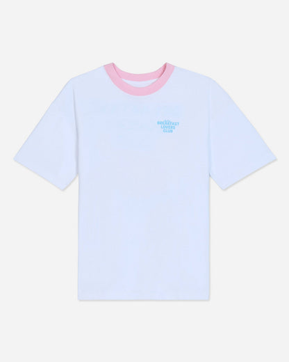 White oversized t-shirt with pink collar and blue left-chest graphic