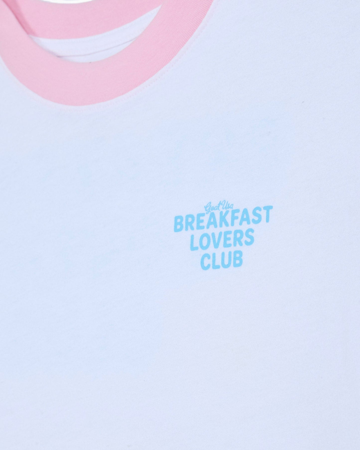 Left chest graphic that reads 'GOAT USA BREAKFAST LOVERS CLUB' on a white oversized t-shirt