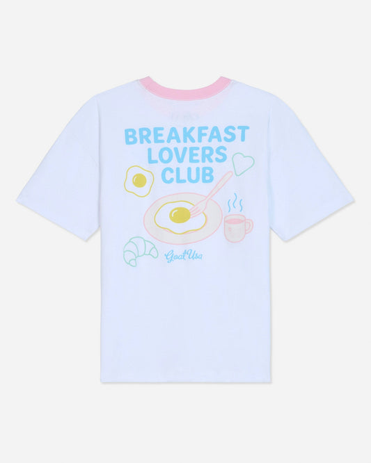 White oversized t-shirt that says 'Breakfast Lovers Club' with various breakfast items