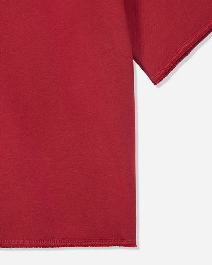 Close-up of a red short-sleeve garment showing the sleeve and hem against a light gray background.#color_tomato