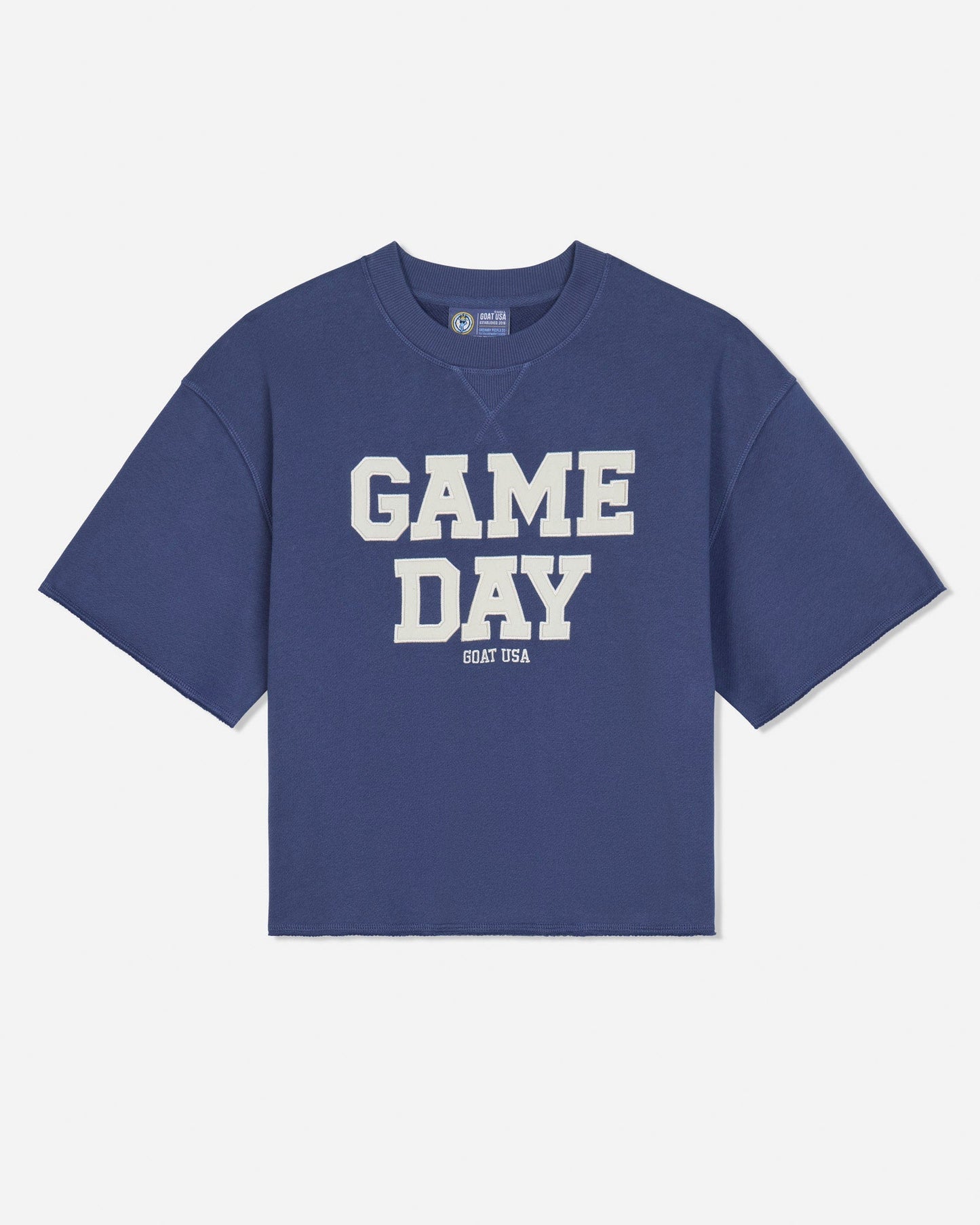 A blue short-sleeve french terry t-shirt with 'GAME DAY' printed in bold white block letters on the front, with 'GOAT USA' printed underneath, shown against a light gray background.#color_navy