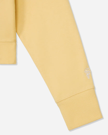 Close-up of sleeve on oversized corn milk crewneck#color_corn-milk